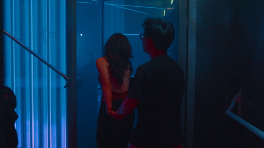 Fuck the Cistem: two people in a blue-lit corridor seen from behind